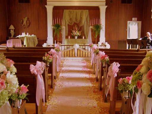 Another bride choose to decorate with pink flowers pink pew bows